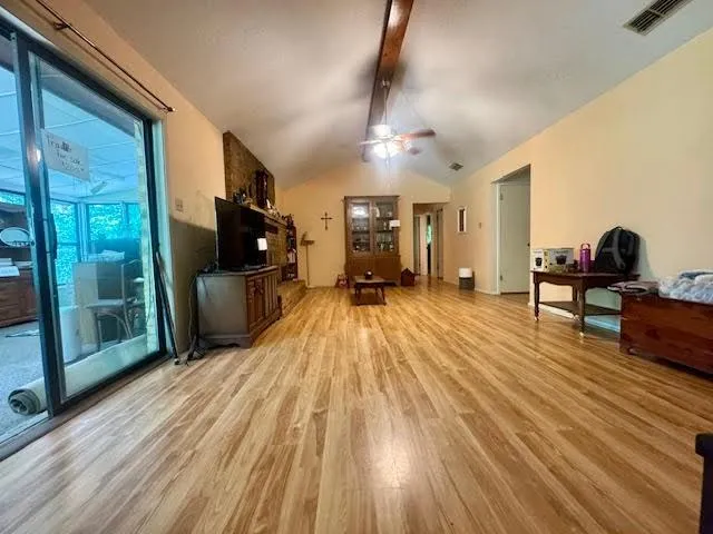 a view of a living room hardwood floor and furniture