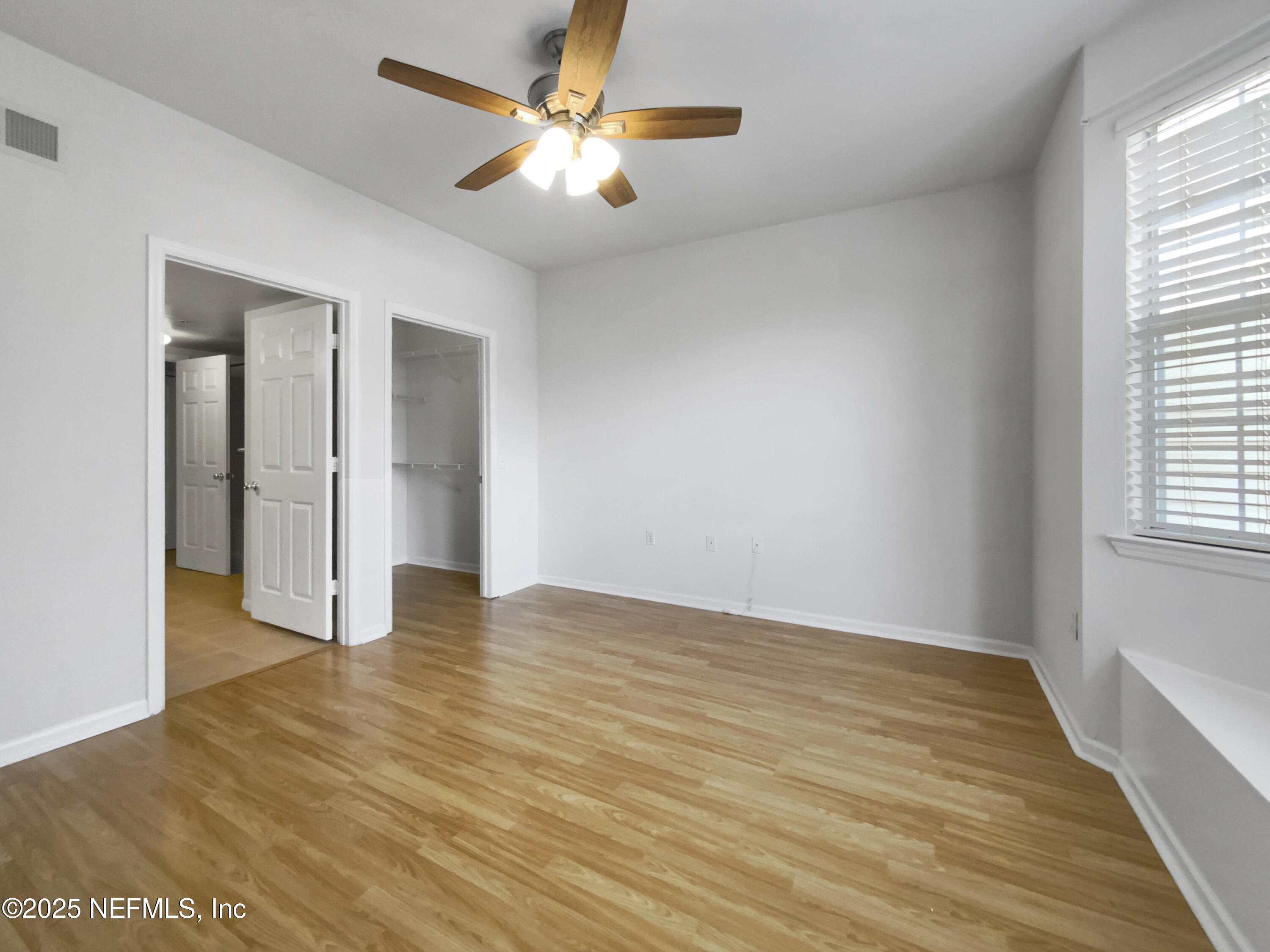 8550 Touchton Road, Unit 635 Jacksonville, FL 32216 - Photo 13 of 25 wooden floor in an empty room with a window