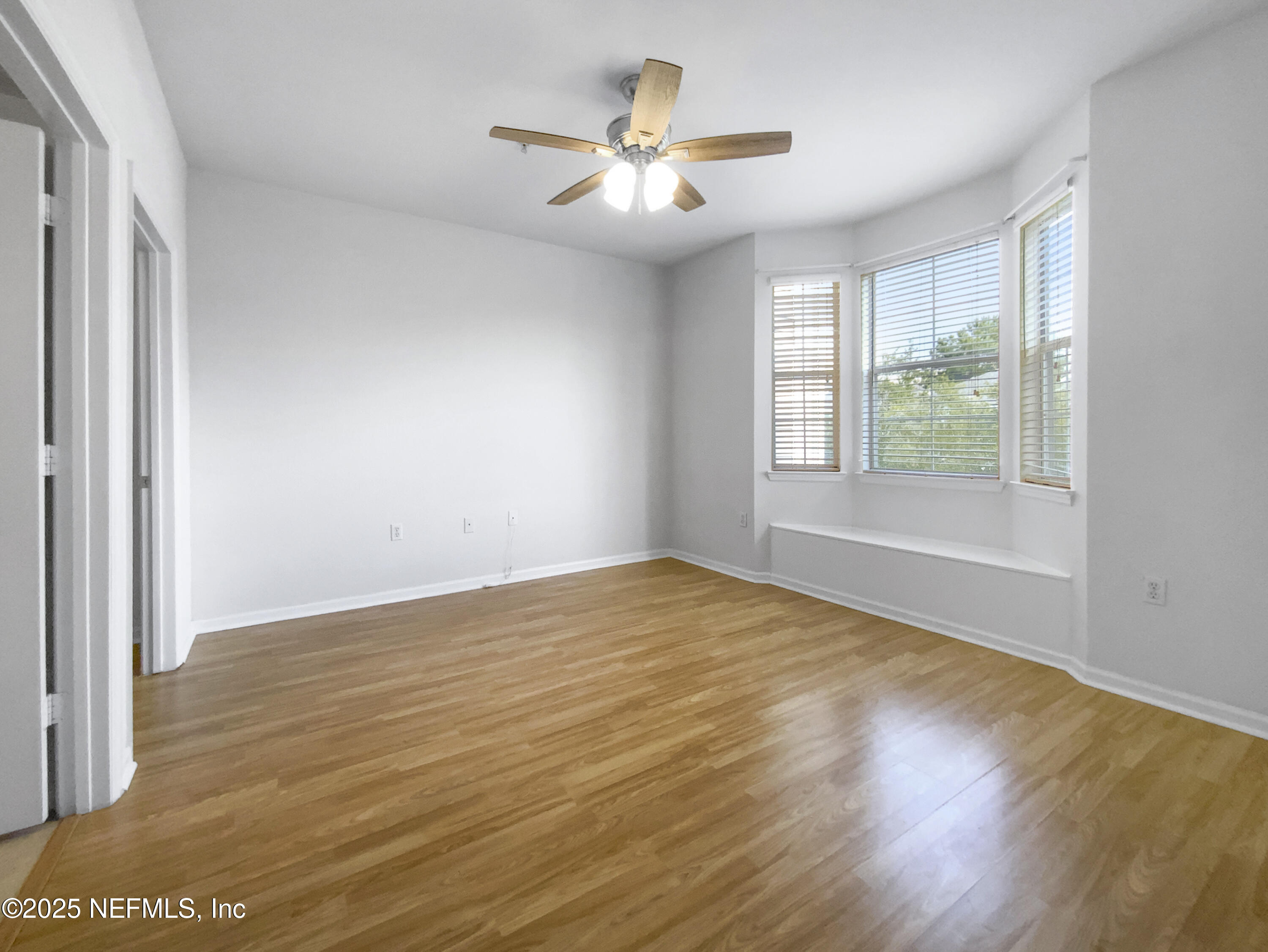 8550 Touchton Road, Unit 635 Jacksonville, FL 32216 - Photo 20 of 25 a view of an empty room with wooden floor and a window