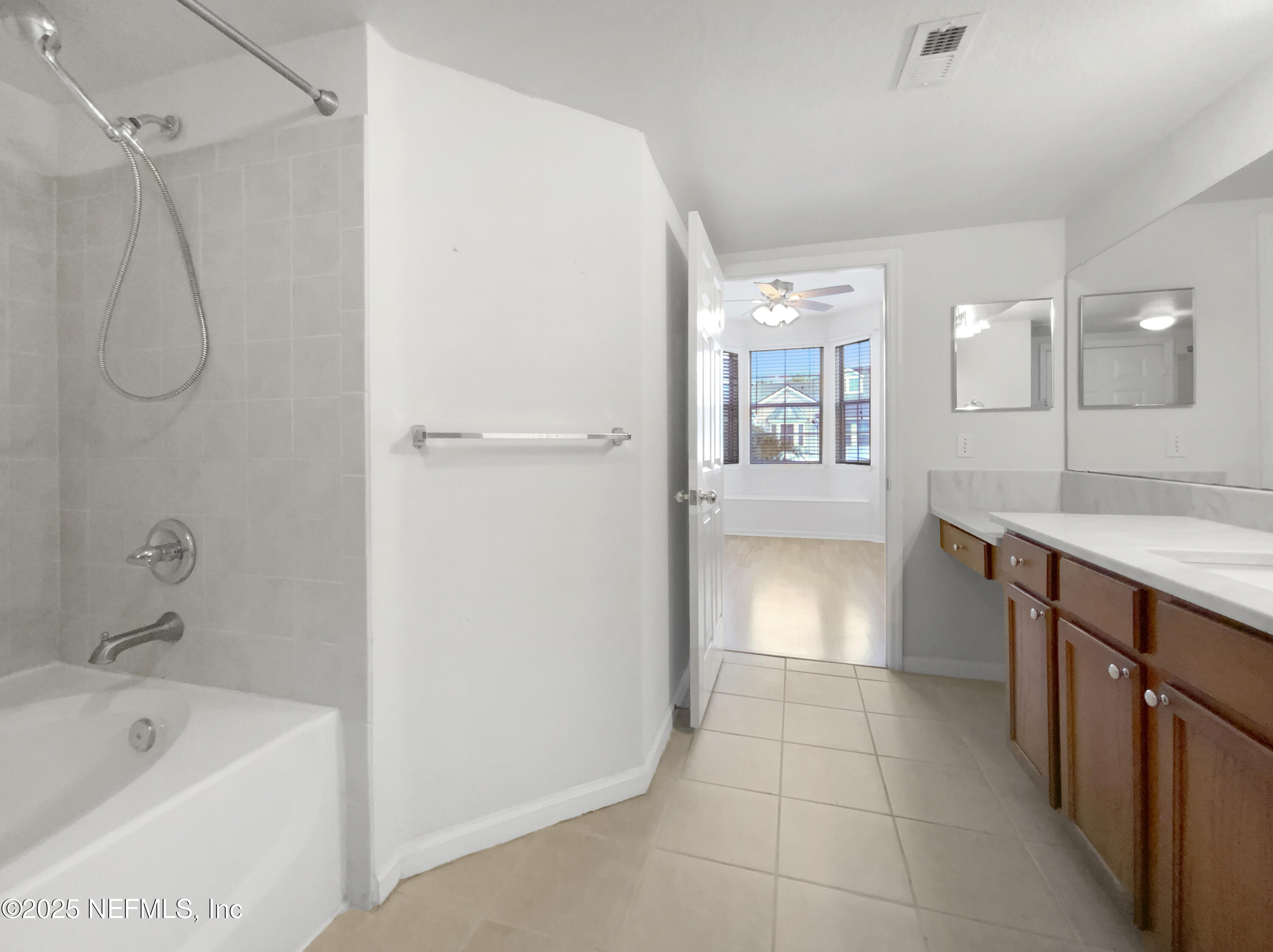 8550 Touchton Road, Unit 635 Jacksonville, FL 32216 - Photo 24 of 25 a bathroom with a bathtub a sink a vanity and shower