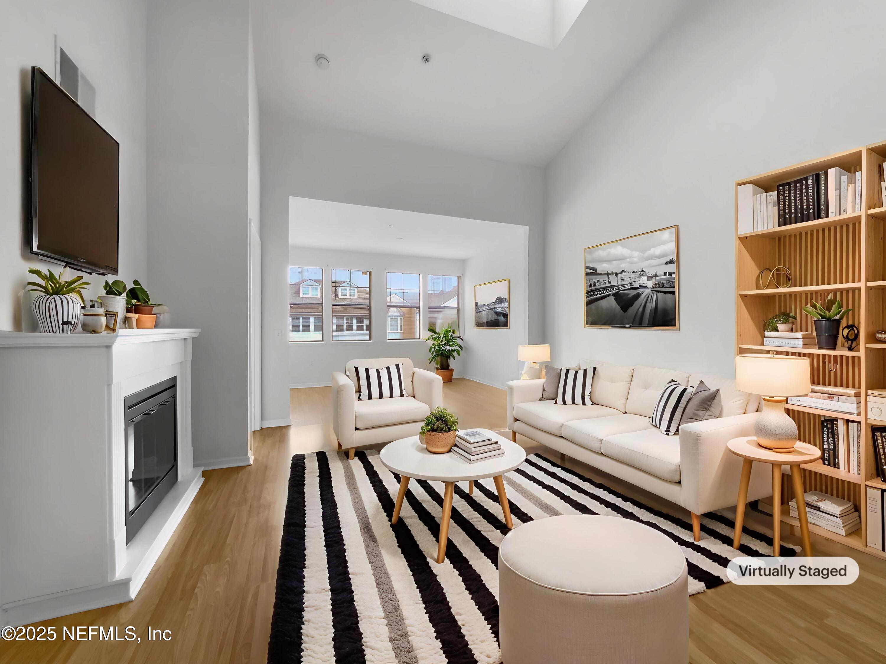 8550 Touchton Road, Unit 635 Jacksonville, FL 32216 - Photo 4 of 25 a living room with furniture a flat screen tv and a fireplace