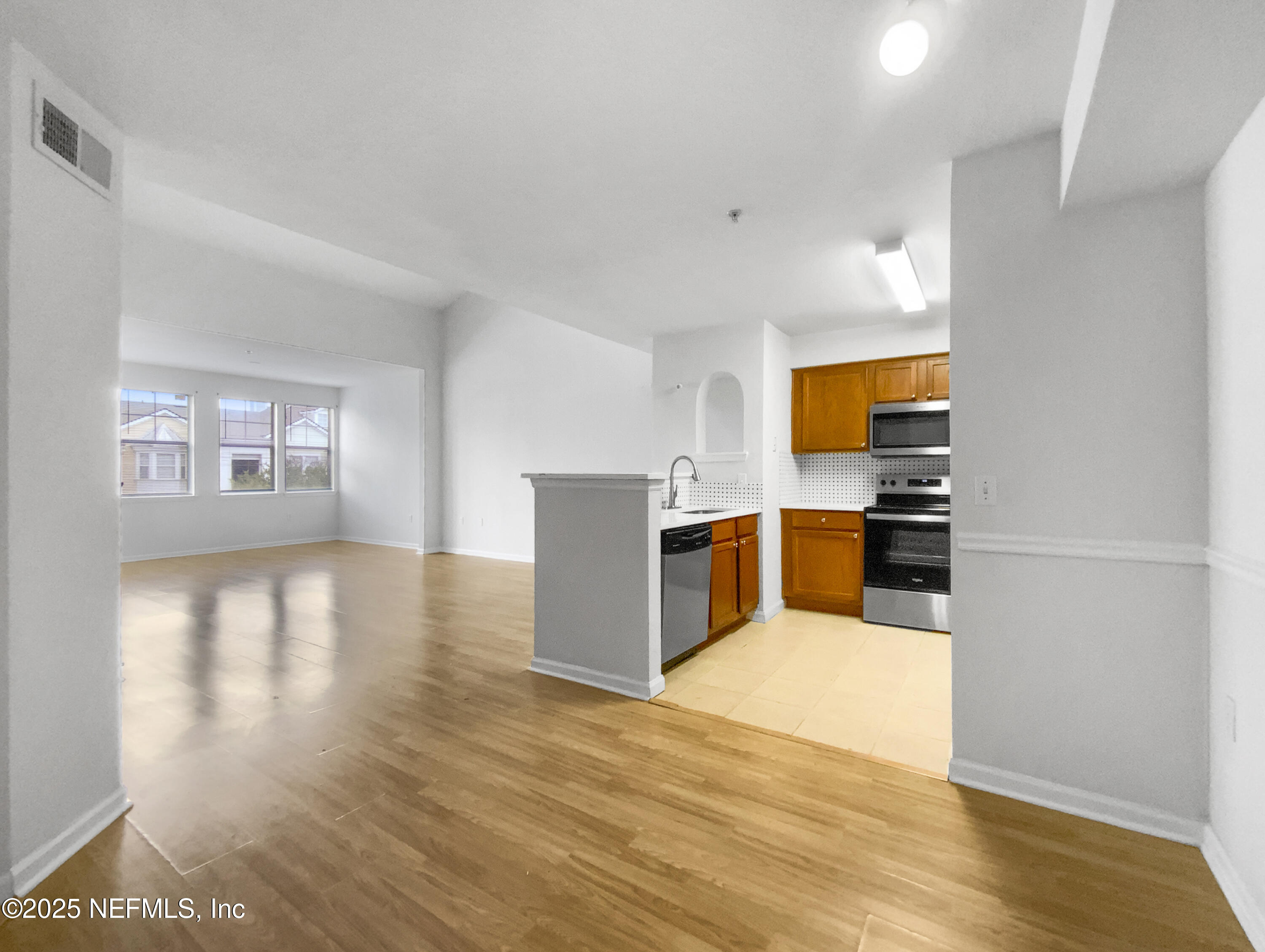 8550 Touchton Road, Unit 635 Jacksonville, FL 32216 - Photo 8 of 25 a kitchen with stainless steel appliances a refrigerator and a stove top oven