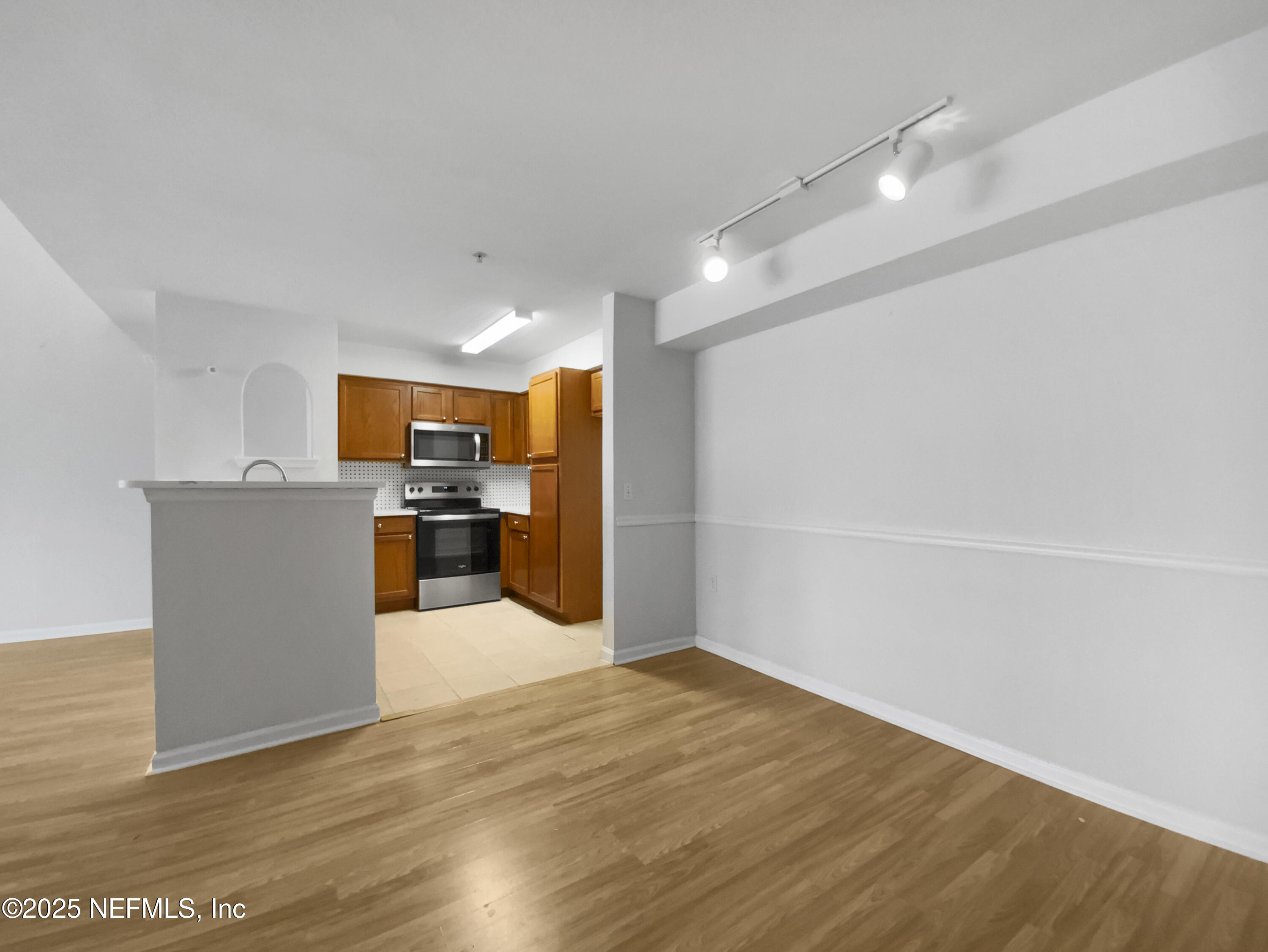 8550 Touchton Road, Unit 635 Jacksonville, FL 32216 - Photo 9 of 25 a view of a kitchen with a sink and a refrigerator