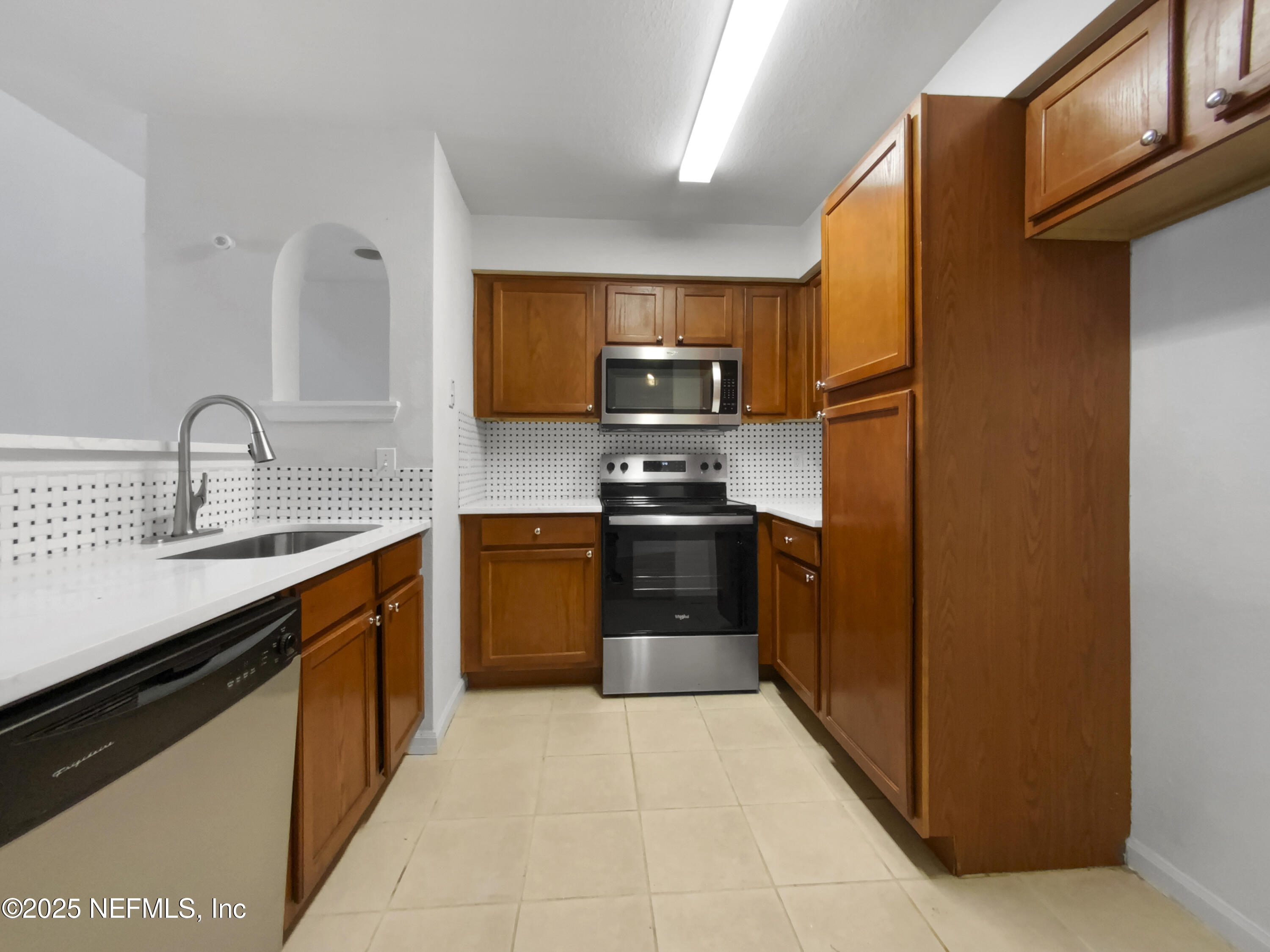 8550 Touchton Road, Unit 635 Jacksonville, FL 32216 - Photo 10 of 25 a kitchen with stainless steel appliances granite countertop a refrigerator and a sink