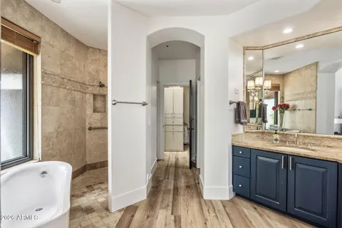 a en suite bathroom with a granite countertop sink toilet and shower