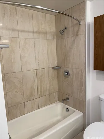 a bathroom with a bathtub and shower