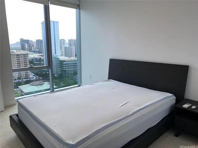 a bed sitting in a bedroom next to a window