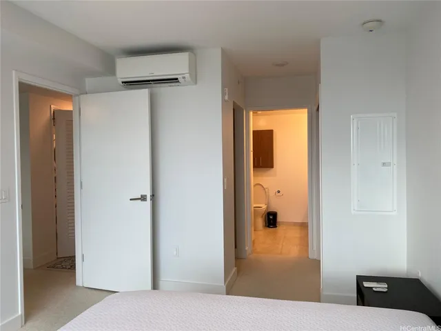 a bedroom with a bed and a view of bathroom