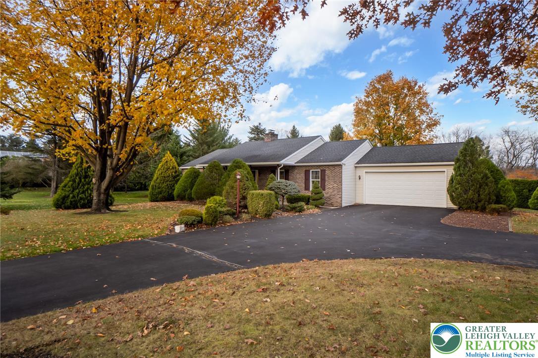 1053 Hilltop Road Leesport, PA 19533 - Photo 1 of 46 a front view of a house with a yard and garage