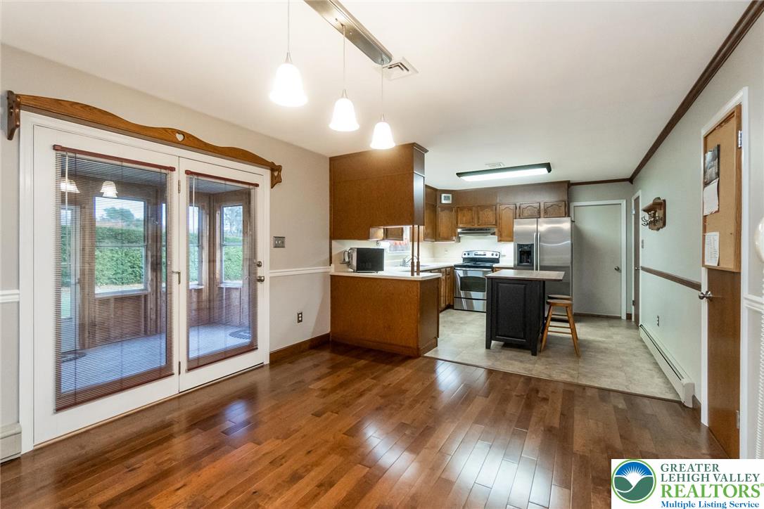 1053 Hilltop Road Leesport, PA 19533 - Photo 17 of 46 a room with stainless steel appliances kitchen island granite countertop a refrigerator a stove and a wooden floors