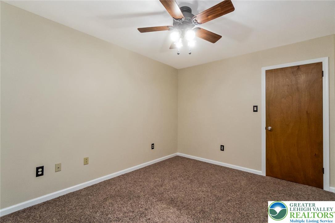 1053 Hilltop Road Leesport, PA 19533 - Photo 22 of 46 an empty room with a ceiling fan and carpet