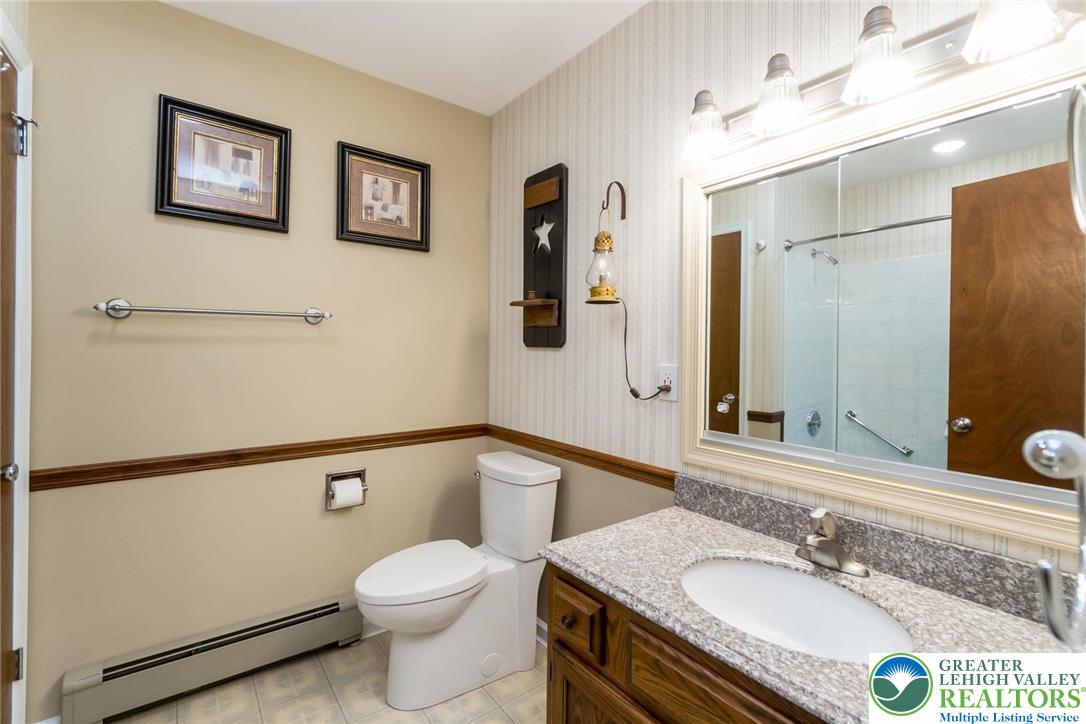 1053 Hilltop Road Leesport, PA 19533 - Photo 23 of 46 a bathroom with a granite countertop toilet sink and mirror
