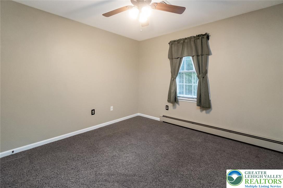 1053 Hilltop Road Leesport, PA 19533 - Photo 25 of 46 an empty room with windows and chandelier fan