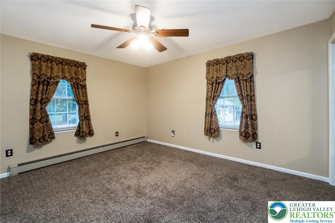 1053 Hilltop Road Leesport, PA 19533 - Photo 27 of 46 an empty room with windows and fan