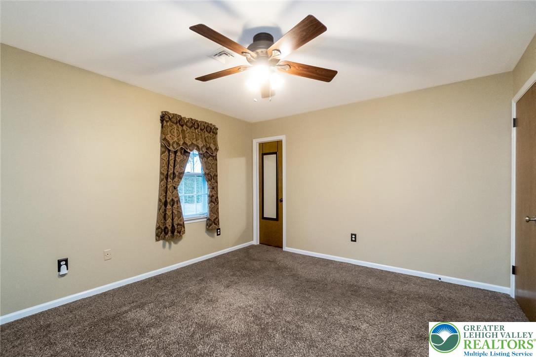 1053 Hilltop Road Leesport, PA 19533 - Photo 28 of 46 an empty room with ceiling fan and windows