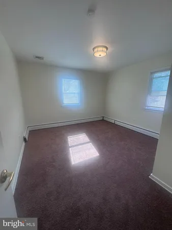an empty room with a empty space and windows