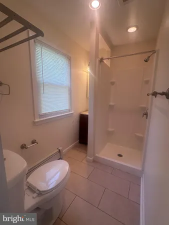 a bathroom with a toilet and shower