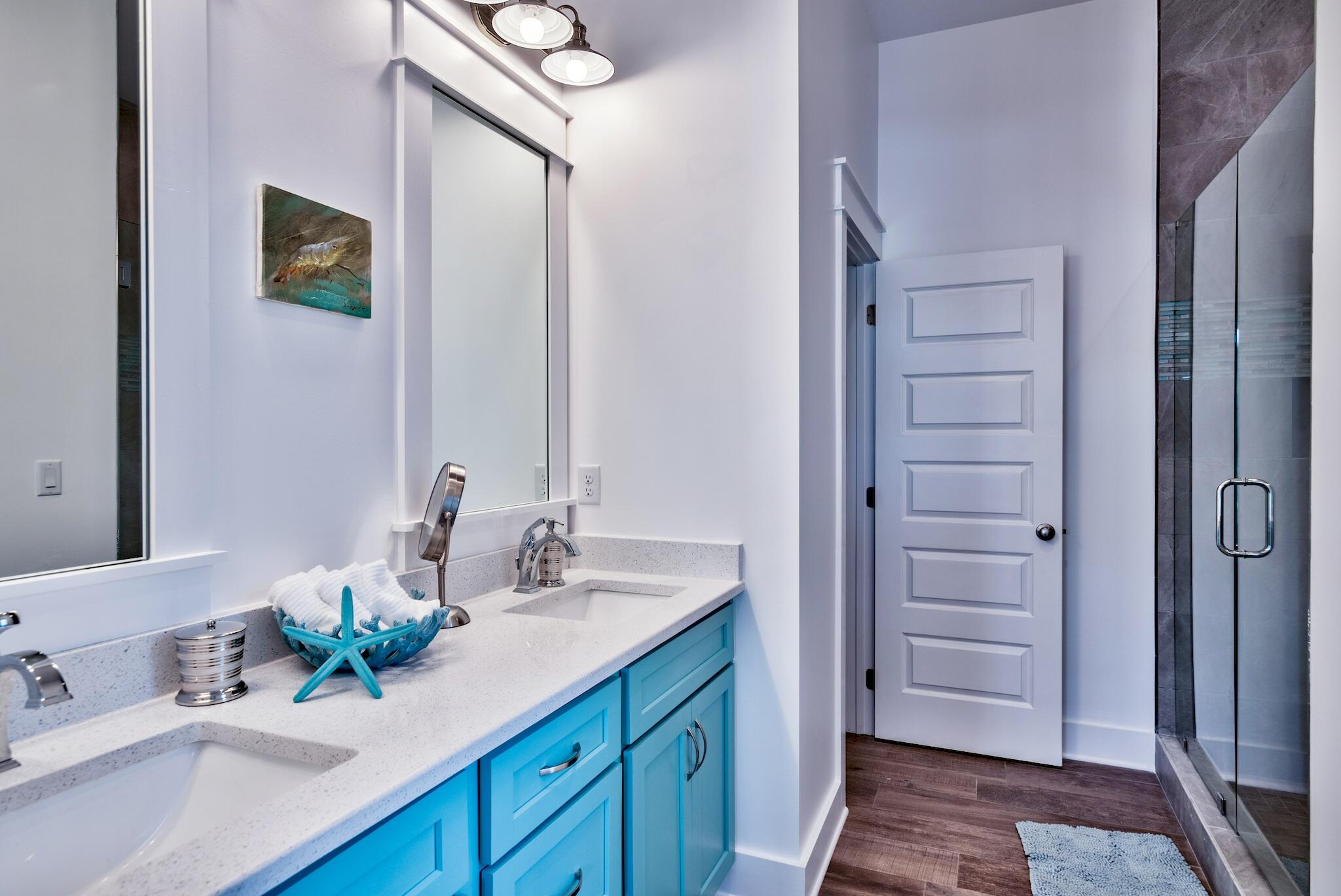4488 Ocean View Drive Destin, FL 32541 - Photo 19 of 23 a bathroom with a sink a mirror and a shower