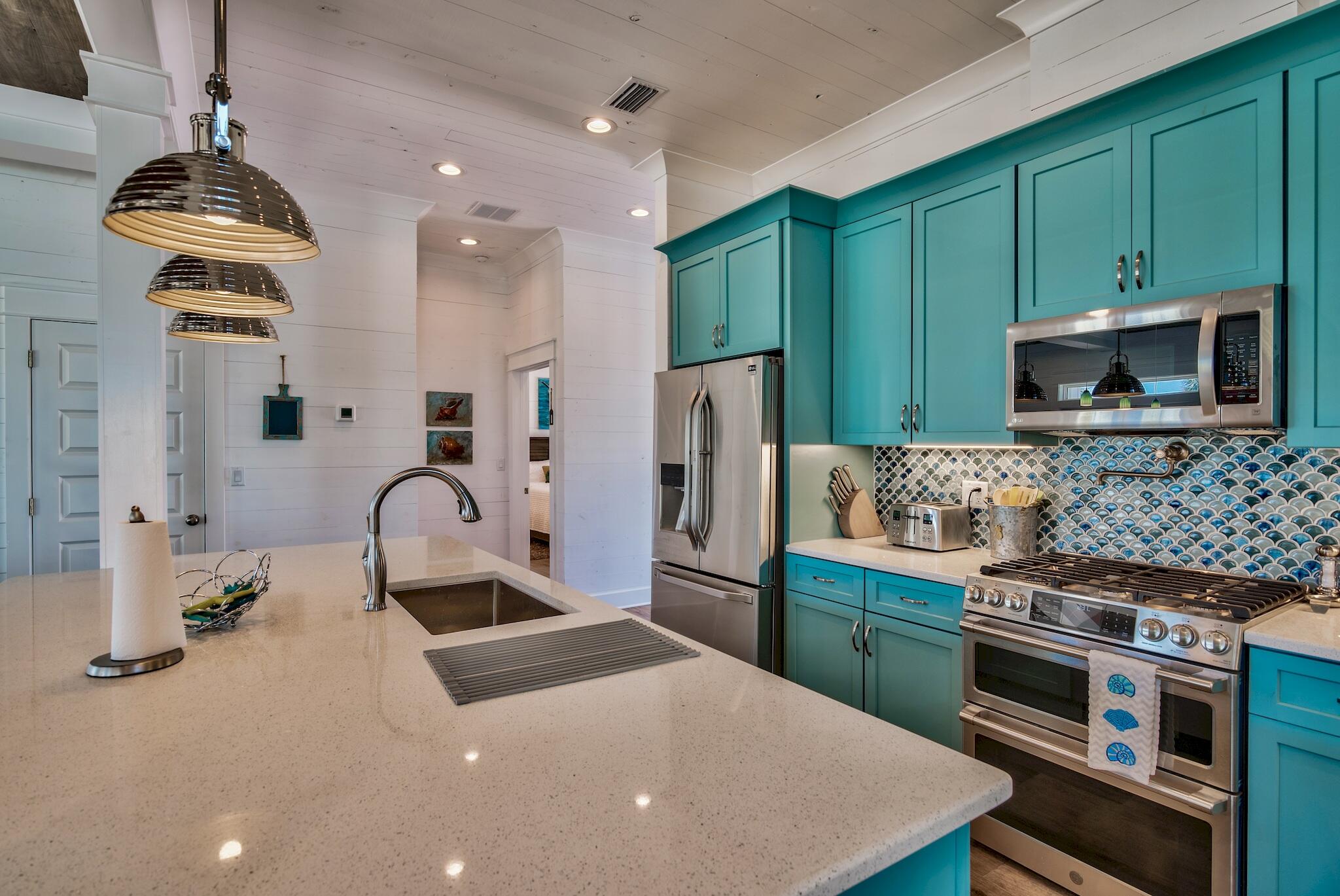 4488 Ocean View Drive Destin, FL 32541 - Photo 22 of 23 a kitchen with granite countertop a stove and a refrigerator