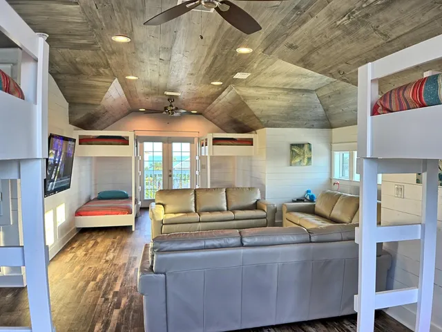 a view of a swimming pool with red chairs