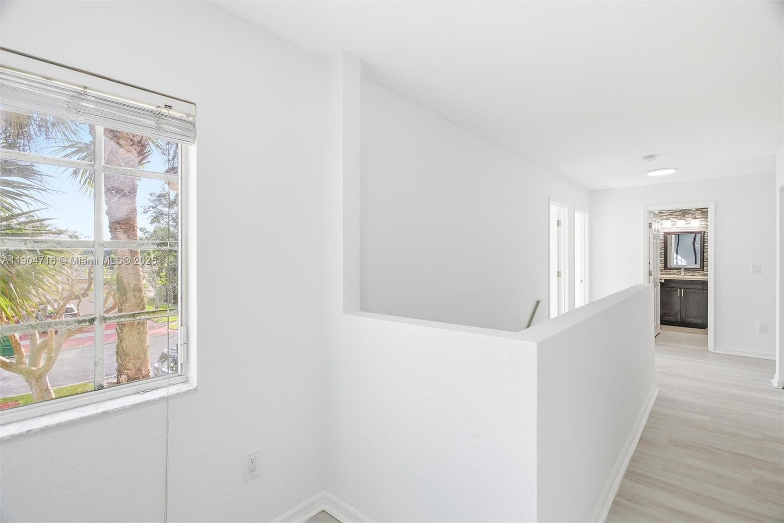 4628 Southwest 125th Lane Miramar, FL 33027 - Photo 17 of 44 a view of a big room with wooden floor and a kitchen