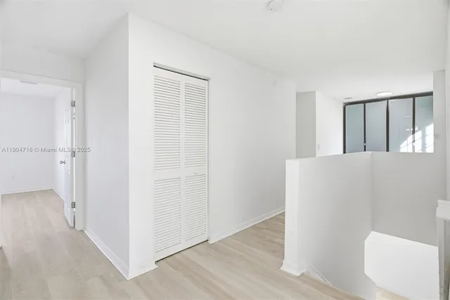 a view of a room with wooden floor