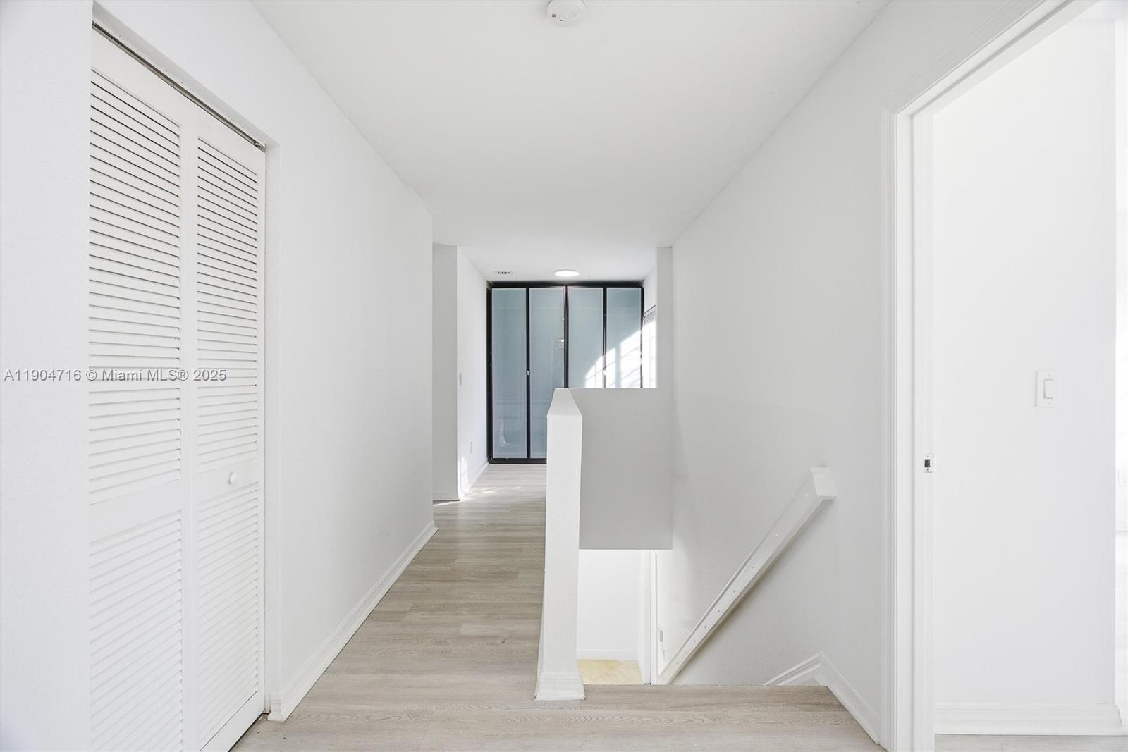 4628 Southwest 125th Lane Miramar, FL 33027 - Photo 19 of 44 a view of a hallway with wooden floor and staircase
