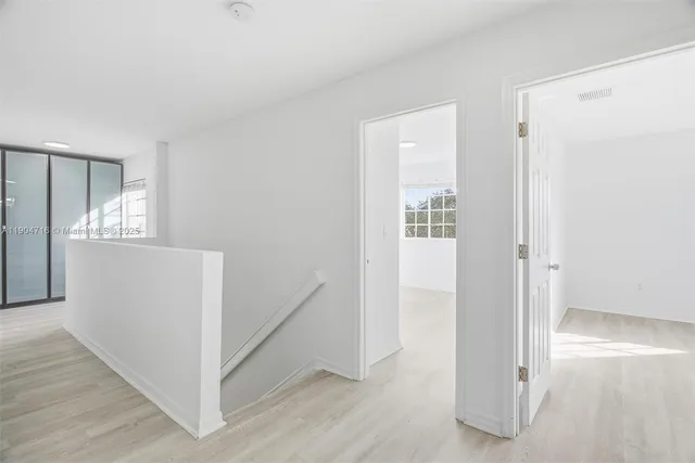 a view of hallway with wooden floor