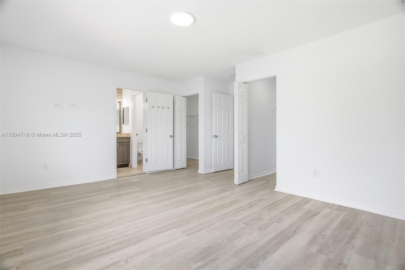 4628 Southwest 125th Lane Miramar, FL 33027 - Photo 24 of 44 a view of an empty room with wooden floor