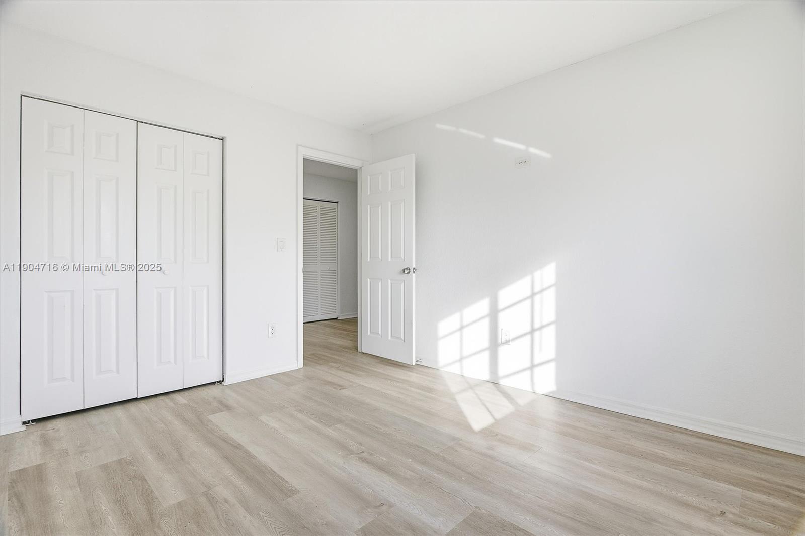 4628 Southwest 125th Lane Miramar, FL 33027 - Photo 29 of 44 a view of empty room with wooden floor and white walls