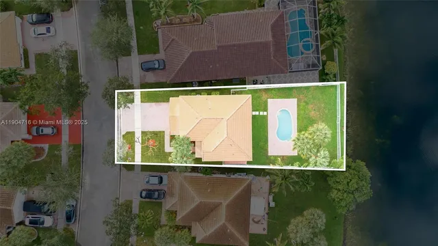 an aerial view of a house with a yard table and chairs