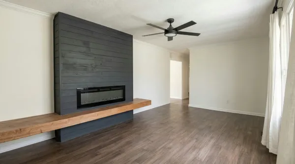 a view of hallway with wooden floor and ceiling fan