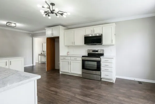 a kitchen with stainless steel appliances a stove top oven and refrigerator