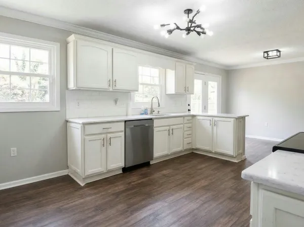 a kitchen with a sink cabinets a window and appliances