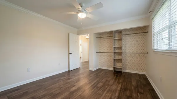 a view of a room with wooden floor and a window