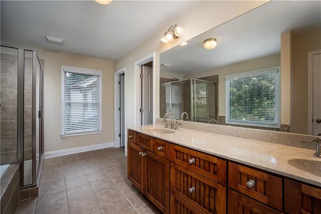 a spacious bathroom with a granite countertop tub sink and mirror