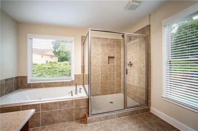 a bathroom with a bathtub and shower