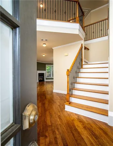 a view of entryway and hall with wooden floor