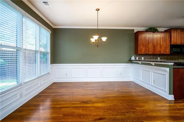 a view of a kitchen with a sink wooden cabinets and a window