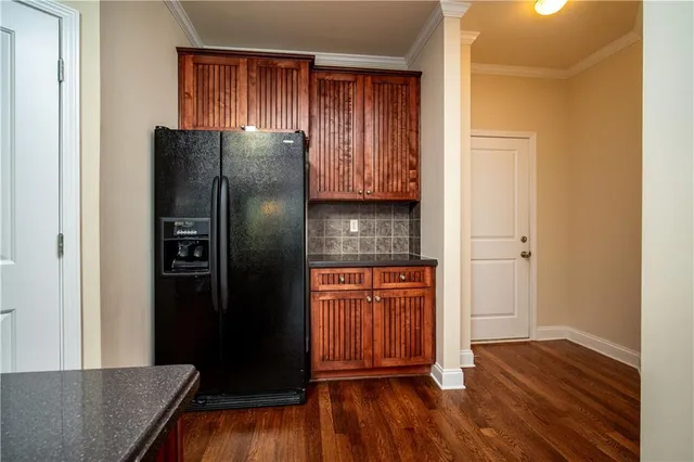 a kitchen with stainless steel appliances granite countertop a refrigerator and a sink