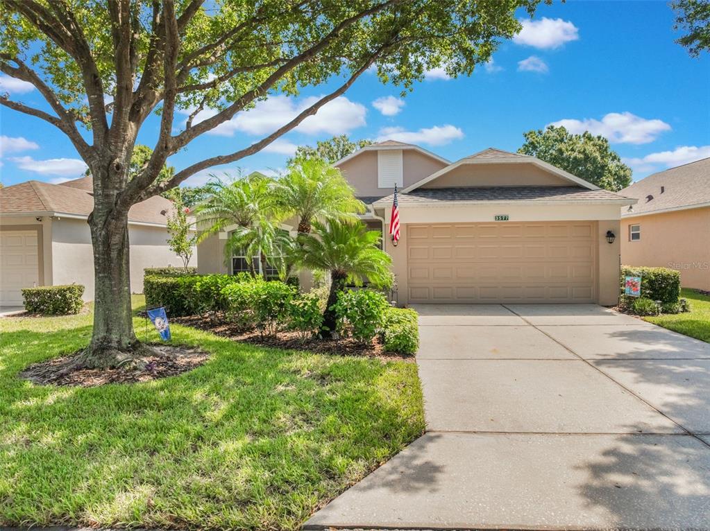 a front view of a house with a yard and garage