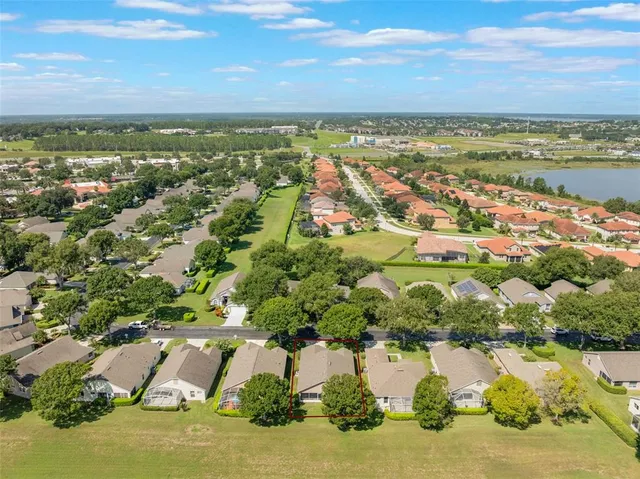 an aerial view of residential building and lake