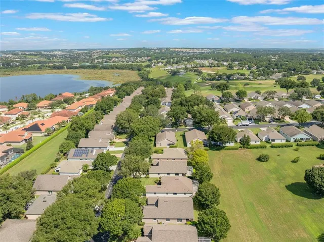 an aerial view of a city with lots of residential buildings ocean and mountain view