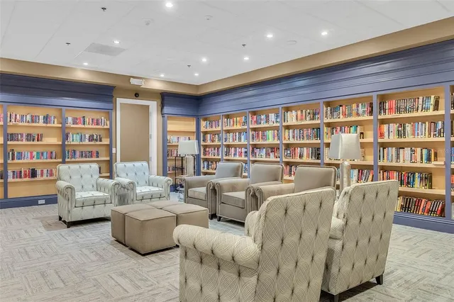 a living room with furniture and a book shelf