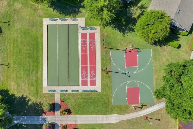 an aerial view of residential houses with outdoor space and swimming pool