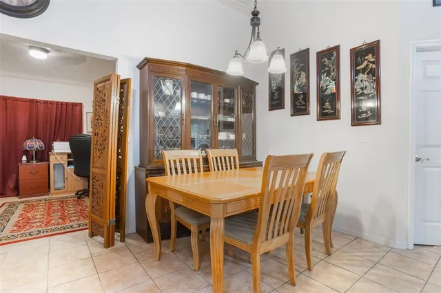 a dining room with furniture and wooden floor