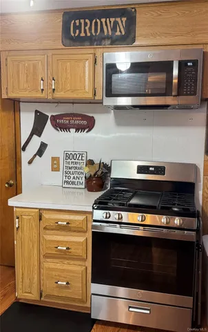 a kitchen with stainless steel appliances granite countertop a stove and a microwave