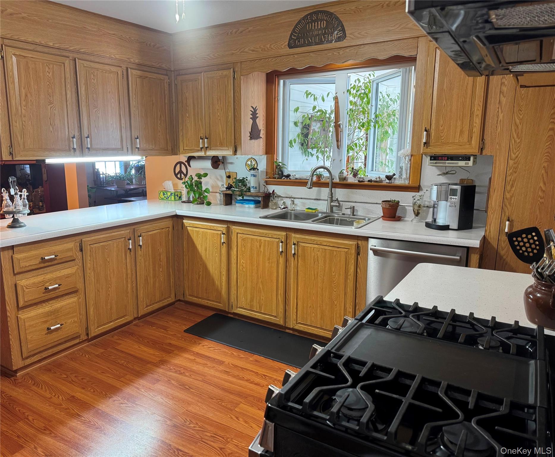 1016 Plains Road Wallkill, NY 12589 - Photo 6 of 14 a kitchen with a stove a window and wooden floor