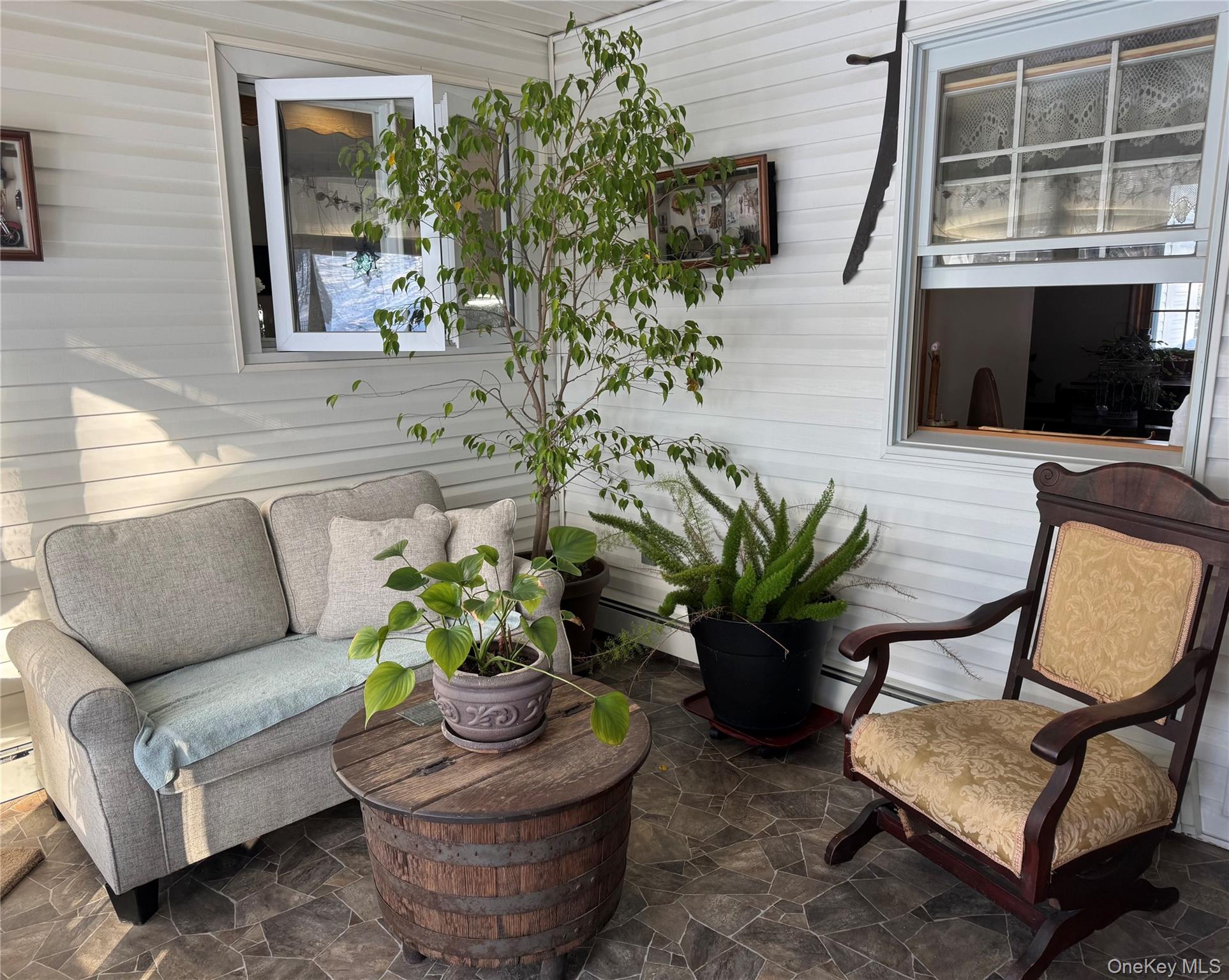 1016 Plains Road Wallkill, NY 12589 - Photo 9 of 14 a living room with furniture potted plant and a window