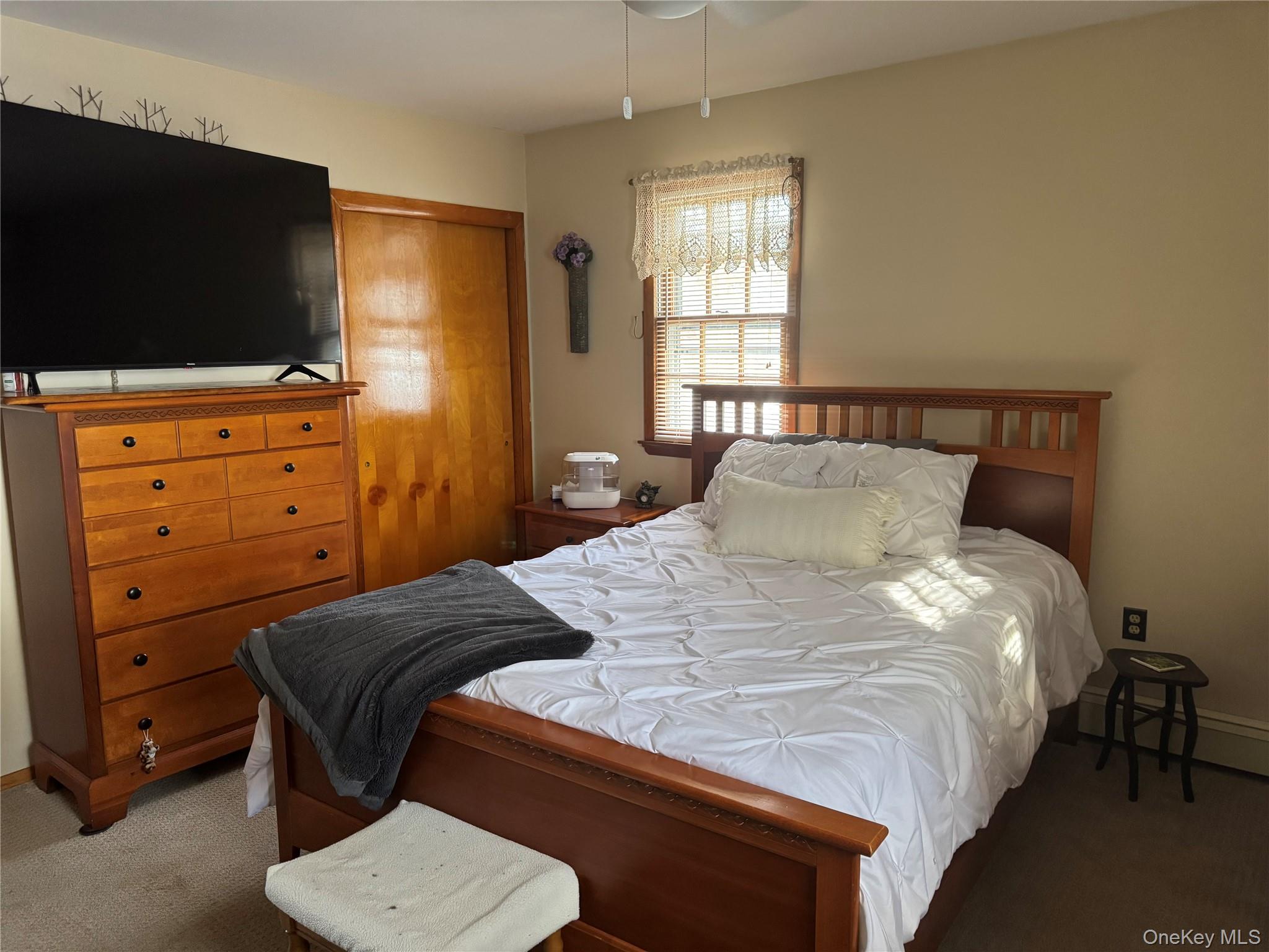1016 Plains Road Wallkill, NY 12589 - Photo 10 of 14 a bedroom with a bed and a flat screen tv